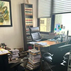 My office is my sanctuary and my second home. It's a space of organized chaos, filled with case files and the tools of my trade.