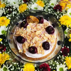 An overhead shot of the Cherry Almond Tres Leches hamper, highlighting the beautiful circular arrangement of the flowers around the cake.