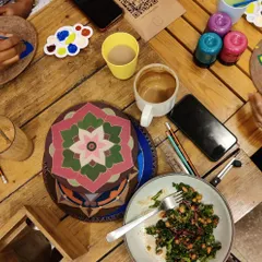 Art, coffee, and a nourishing meal. This overhead shot captures the perfect blend of creativity and comfort at our workshops.