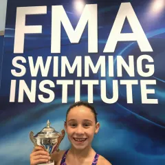Another proud FMA swimmer with her well-deserved trophy. We celebrate every achievement, big and small, as our students progress on their competitive journey.