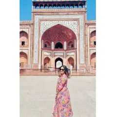A panoramic-style shot of me at the entrance of the Taj Mahal, capturing the grand scale of the architecture.