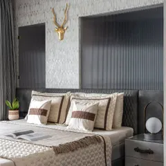 This all-monochrome master bedroom is a symphony of textures. A grey leather bed, cherry wood flooring, and a fluted glass partition create a space that is warm, cozy, and incredibly inviting.