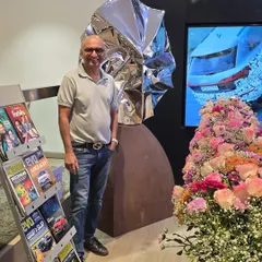 At a group show at the Audi Mumbai South showroom, standing with my sculpture "Eclipse."