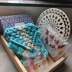 Here is another variation of a custom gift hamper. This one features a beautiful blue macrame purse, a unique necklace set, and some of my signature handmade earrings, all ready to be gifted.