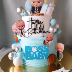 For little Nyhaan's first birthday, we created this fun two-tiered Boss Baby cake. It's one of my most requested cartoon themes, and I love bringing this character to life with lots of fun details, all completely eggless.
