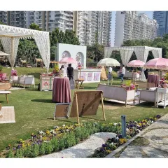 For this chic daytime event, we designed a relaxed oasis with custom-printed tents, comfortable lounge seating, and vibrant floral arrangements. This setup shows how we blend modern style with traditional motifs for outdoor celebrations.