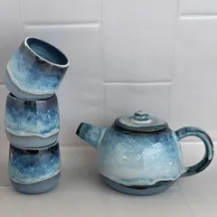 A beautiful, wheel-thrown tea set with a glaze that reminds me of a misty morning. The set includes a teapot and three matching handleless cups.