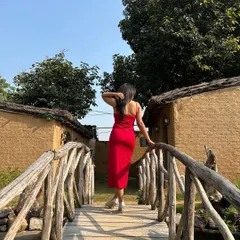 A back view of the red slit dress, highlighting its simple yet elegant silhouette. Sometimes, the most impactful looks are the ones that are clean and confident.