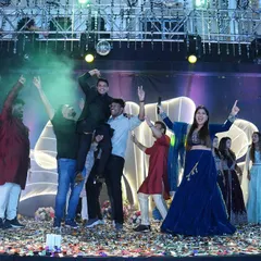 A Sangeet night is all about celebration. Here I am with the groom's squad, hyping them up on stage with confetti, smoke, and unstoppable energy.