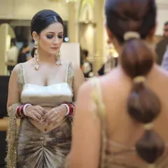 A stunning bridal look from behind. This modern bubble ponytail is a chic and fashionable choice for a bride who wants a unique hairstyle.