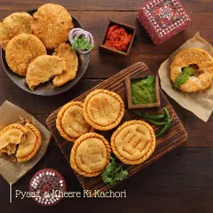 A platter of our most-loved kachoris. On one side, the classic spicy Pyaaz Ki Kachori, and on the other, our unique Sheherwali special, Kheere Ki Kachori, served with homemade chutneys.