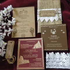 For a warm and rustic aesthetic, we offer this beautiful handcrafted jute invitation suite. The set includes multiple inserts for different events like the Muhurtham, Haldi, and Sangeet, all wrapped in a natural jute pouch adorned with lace and a custom wooden tag.
