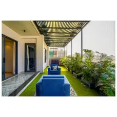 This balcony is a private green oasis in the city. I used artificial turf, comfortable outdoor furniture, and a slatted pergola to create a perfect space for relaxing and enjoying the view.