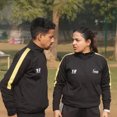 Coaching is about connection and communication. This candid shot captures the intensity and focus of our coaches as they work together to refine strategies and improve player outcomes.