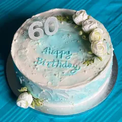 A simple yet elegant cake to celebrate a 60th birthday. The design features a soft blue watercolor effect on buttercream, delicate white roses, and a sparkling "60" to mark the special milestone.