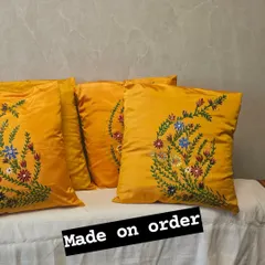 Brighten up your home with these custom-made silk cushion covers. This set of four vibrant yellow pillows features a delicate, hand-painted floral design, perfect for adding a touch of elegance and personality to any living space.