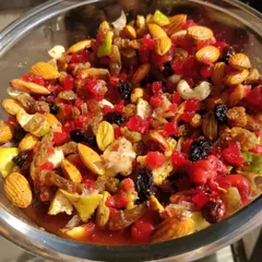 A close up of our Christmas fruit mix after soaking. This colorful and aromatic blend of nuts, berries, and candied fruits is what gives our rum and plum cakes their signature taste.