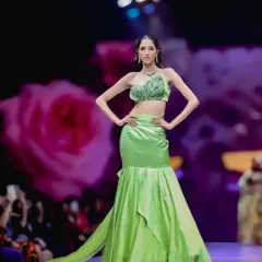A full-length shot of the same green outfit, showing the mermaid-style skirt and intricate top. This is a key shot for a designer's lookbook.