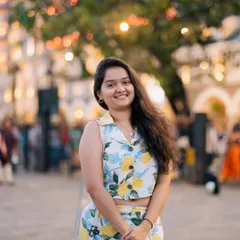 A closer shot from the same session, focusing on her expression. The blurred background with bokeh lights adds a touch of magic to this daytime portrait.