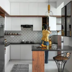 For our 'Utopian Dreams' project, we created a compact bar and breakfast counter adjacent to the kitchen. This versatile zone serves as a spot for quick meals and an entertainment hub, making it the heart of the home.