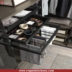 Our pull-out trouser rack keeps pants neatly hung and wrinkle-free. Above it, a compartmentalized drawer provides the perfect home for belts and other small accessories.