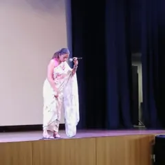 On stage at Greenwood High, I'm demonstrating how to stand correctly to distribute body weight, a crucial tip for teachers who are on their feet for many hours. Practical advice is at the core of my talks.