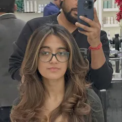 A selfie with the client, showing off her refreshed color. The highlights are perfectly placed to complement her features, even with glasses on.