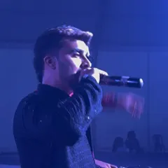 On the mic during a Dandiya Mahotsav, engaging with a crowd of over 10,000 people. I'm experienced in hosting and DJing for large-scale concerts and festivals.