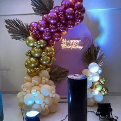An elegant and unique color combination of purple, gold, and cream. This balloon arrangement with dried palm leaves shows how I can create a sophisticated look for any birthday.