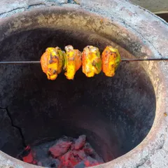 Another shot of our paneer tikka on a skewer, being cooked over hot coals in a clay tandoor for that unmistakable taste.