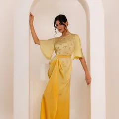 A beautiful shot from the same indo-western shoot. The model is wearing a draped yellow dress with bell sleeves, and the arched backdrop adds a touch of architectural elegance.