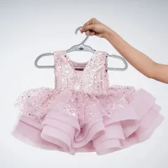 A beautiful baby frock in pink with a sequined top and a layered organza skirt. This party dress is available to rent or buy.
