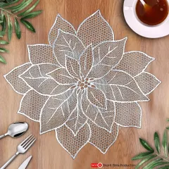 A beautifully styled top-down shot of a lace table mat. We create complete scenes with props like cutlery and tea to help customers visualize the product in their own home.