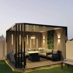 This rooftop terrace was converted into a luxurious outdoor lounge, complete with a modern pergola for shade. The design includes a large L-shaped sofa, integrated vertical lighting for dramatic effect, and a green wall accent, perfect for hosting and entertaining.