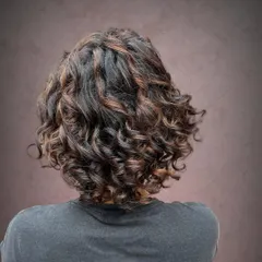 Pintura highlights for Shraddha. This technique is perfect for adding definition to curly hair without harsh lines.