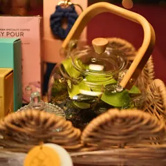 A closer look at the teapot terrarium nestled within one of my festive gift baskets. The combination of living plants and other curated goods makes for a truly unique and sustainable gift.