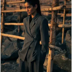 Moving away from the water, we used the rustic, rocky shoreline to create a different texture and mood. The hard lines of the rocks contrast with the soft tailoring of the suit.