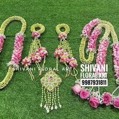 This is a complete bridal set I created, featuring a floral necklace, earrings, and heavy kalire made from jasmine buds and pink roses. The set also includes a matching shela for the bride's entry.