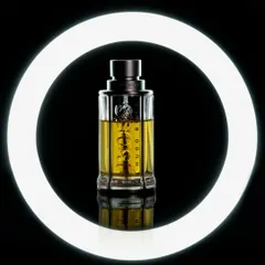 For this perfume shot, I used a ring light to create a bold, graphic frame around the bottle. This technique isolates the product against a pure black background, emphasizing its clean lines and the color of the fragrance. It is ideal for modern digital marketing and social media visuals.