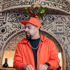 On the decks at Bastian during the Gypsy Groove event. The orange jacket and festive decor set the mood.