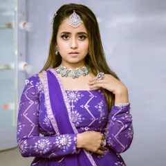 A close-up view of the purple lehenga's intricate blouse and dupatta work, showing the quality of the embellishments.