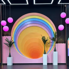 Our pastel rainbow arch set is a favorite for content creators. The warm, concentric colors and playful design elements like the palm trees and orb lights make it a ready-to-shoot backdrop for vibrant and trendy visuals.