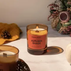 A bright, airy shot of an Autumn Shade candle, styled with seasonal elements to create a fresh and inviting product image.