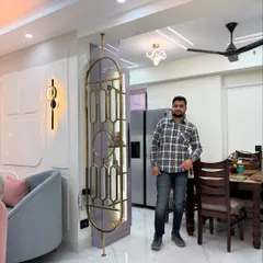 Here I am in a recently completed living and dining space. You can see the elegant metal partition that separates the areas without blocking light, and the cohesive design that flows from the seating area to the dining table.