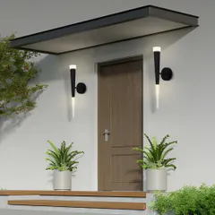 These torch-like wall sconces are suitable for both indoor and outdoor use. Here they are flanking an entryway, creating a welcoming and modern first impression.