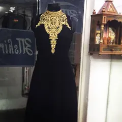 This black and gold gown is a perfect example of my Indo-Western fusion designs. The traditional zari embroidery around the neck acts as a built-in necklace, making it both elegant and easy to style for an evening event.