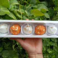 A perfect festive gift set, this box contains two laddoo candles and three modak candles, all decorated with gold leaf. It's a unique twist on traditional sweets.