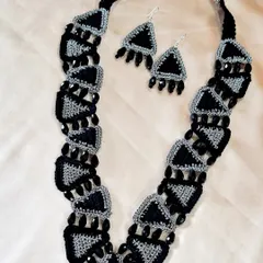 A complete set of our custom-made triangular-motif jewellery, including the statement necklace and matching earrings. The combination of black, grey, and beadwork creates a striking, modern-ethnic look.