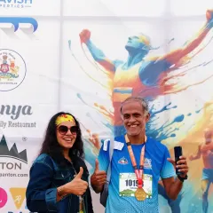 Posing with an enthusiastic runner after the event. I get my inspiration from the participants, and my goal is to make them feel like champions.