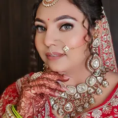 A detailed close-up of this gorgeous bridal look. I focused on creating luminous skin, softly defined eyes, and a neutral lip color that allowed her magnificent kundan jewelry and red embroidered lehenga to shine.